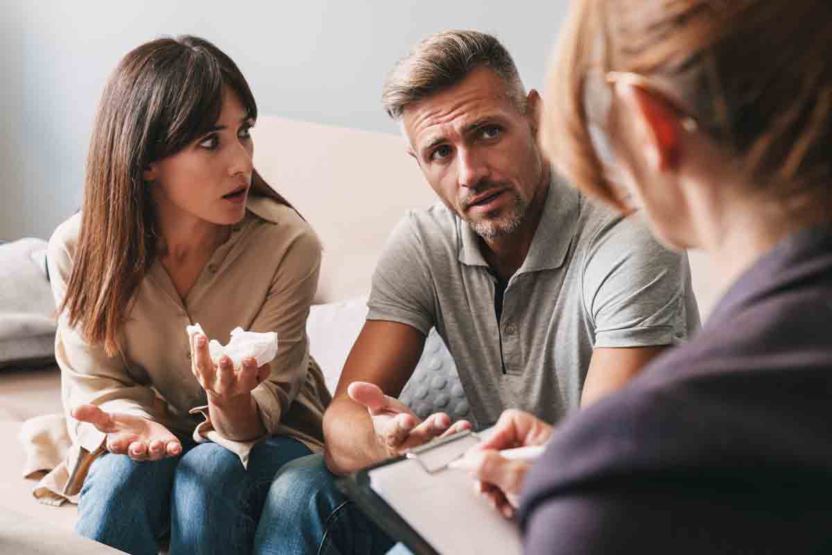Couple discussing relationship patterns with a therapist during a counseling session