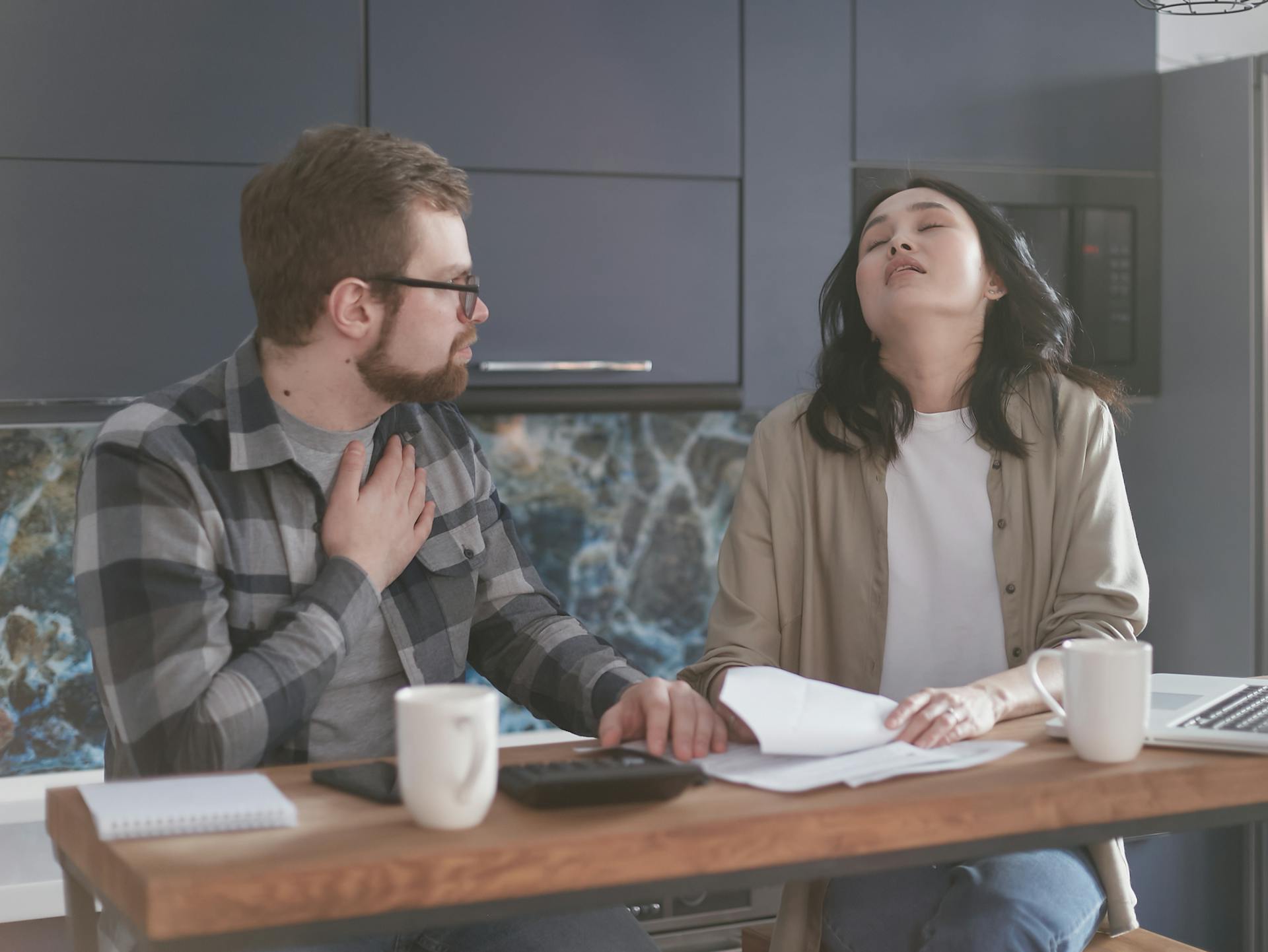 Frustrated couple dealing with emotional stress and relationship tension while discussing difficult topics